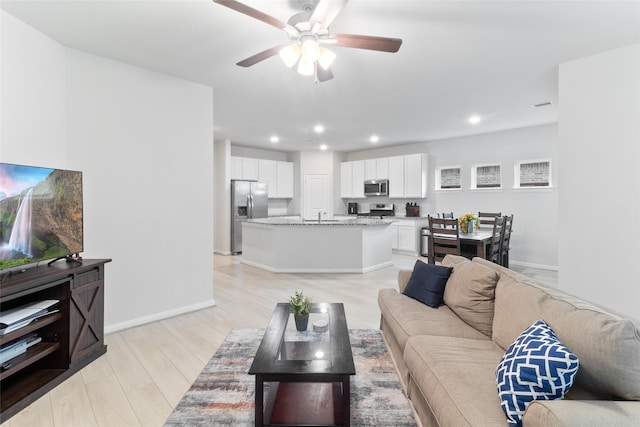214 Water Grass Trl, Clute, TX 77531 - living room featuring recessed lighting, ceiling fan, and light wood finished floors