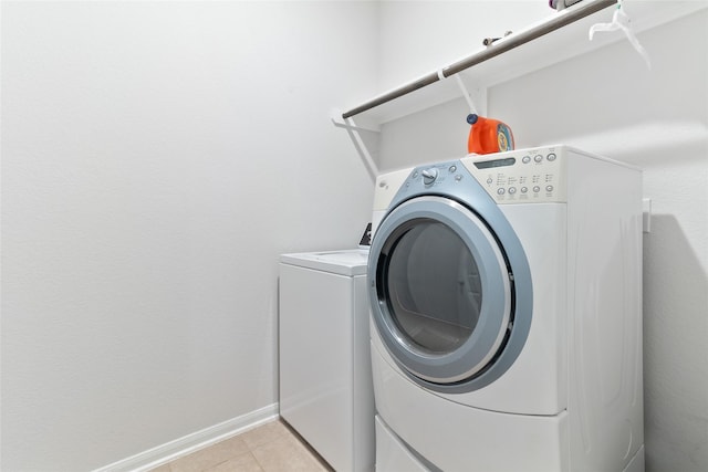 214 Water Grass Trl, Clute, TX 77531 - laundry room featuring washer and dryer and light tile patterned floors