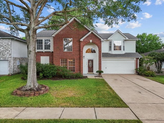 1726 Kemah Oaks Dr, Kemah, TX 77565 - traditional-style house featuring brick siding, a garage, driveway, and a front yard