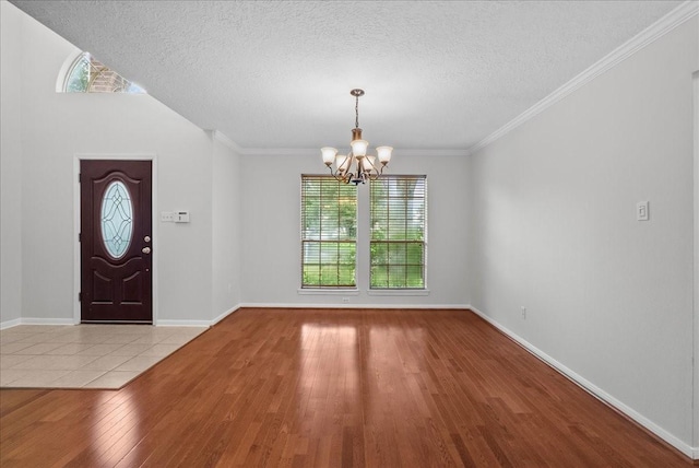1726 Kemah Oaks Dr, Kemah, TX 77565 - entrance foyer with wood finished floors, a chandelier, and a textured ceiling
