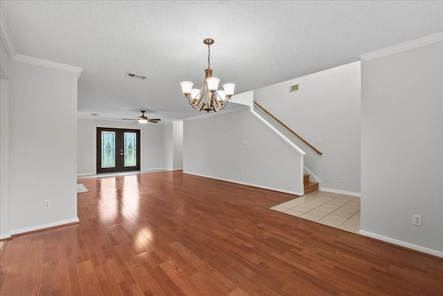 1726 Kemah Oaks Dr, Kemah, TX 77565 - unfurnished living room featuring a chandelier, wood finished floors, crown molding, ceiling fan, and stairway