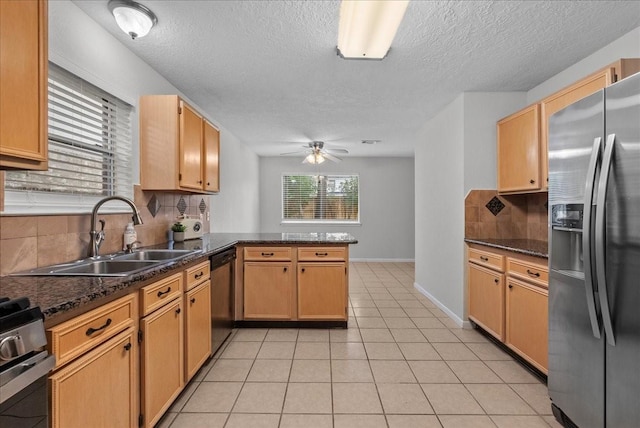 1726 Kemah Oaks Dr, Kemah, TX 77565 - kitchen with stainless steel appliances, a peninsula, ceiling fan, decorative backsplash, and a textured ceiling