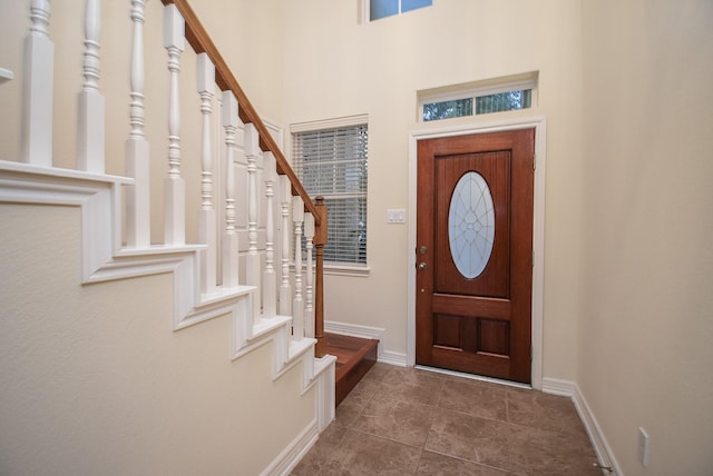28015 Silverstream Ct, Fulshear, TX 77441 - foyer featuring stairs and dark tile patterned floors