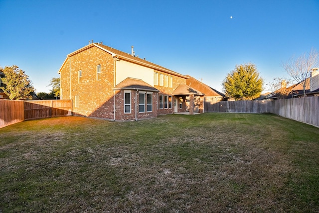 28015 Silverstream Ct, Fulshear, TX 77441 - rear view of house with a fenced backyard and brick siding