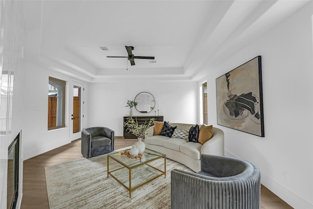 2031 Peppermill Rd, Houston, TX 77080 - living room featuring a raised ceiling, ceiling fan, and wood finished floors