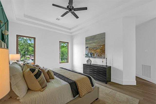 2031 Peppermill Rd, Houston, TX 77080 - bedroom featuring wood finished floors, a raised ceiling, and ceiling fan