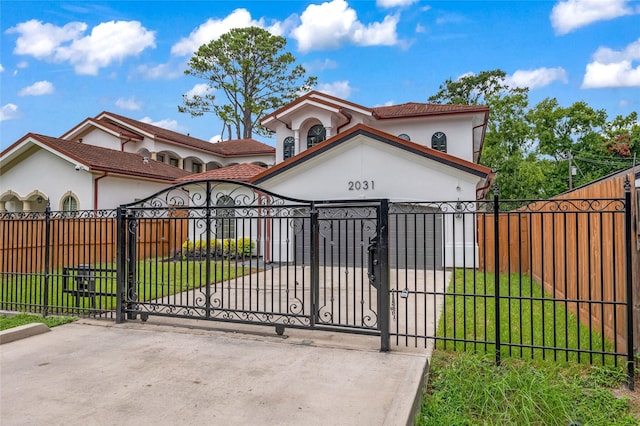 2031 Peppermill Rd, Houston, TX 77080 - mediterranean / spanish home with a fenced front yard, stucco siding, a tiled roof, and a gate
