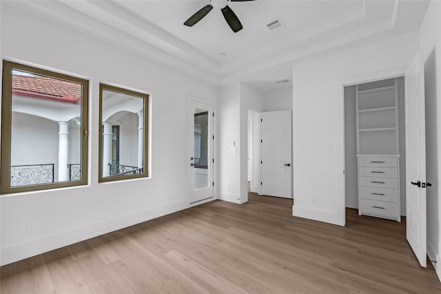 2031 Peppermill Rd, Houston, TX 77080 - unfurnished bedroom featuring a raised ceiling, wood finished floors, and a ceiling fan