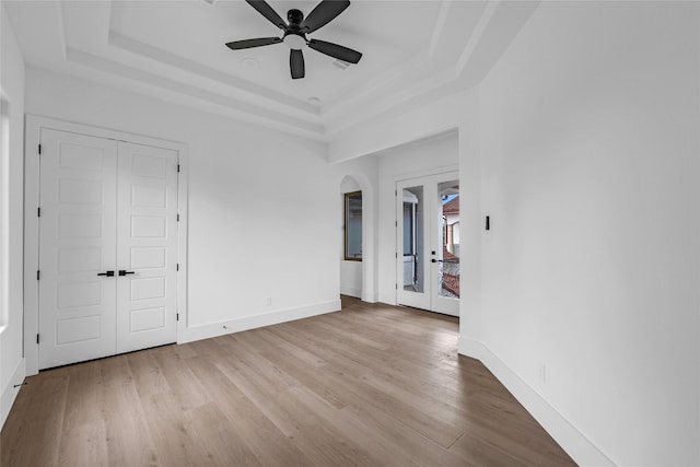 2031 Peppermill Rd, Houston, TX 77080 - spare room with a tray ceiling, french doors, wood finished floors, and arched walkways