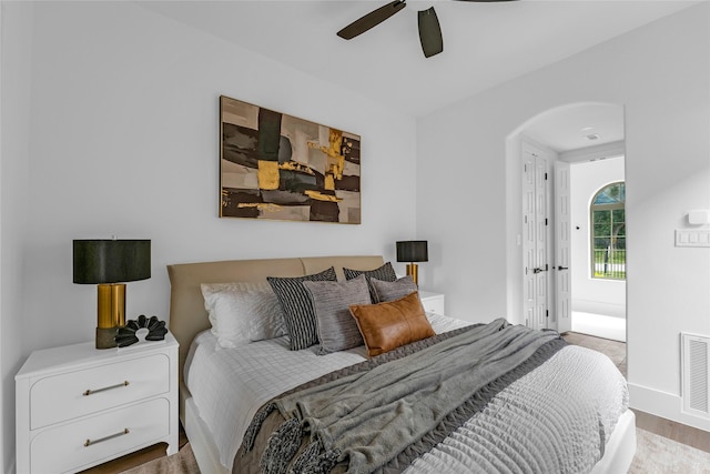 2031 Peppermill Rd, Houston, TX 77080 - bedroom with arched walkways, ceiling fan, and wood finished floors