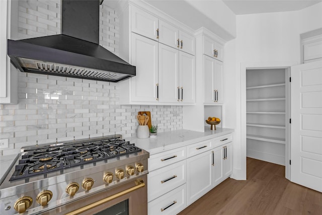 2031 Peppermill Rd, Houston, TX 77080 - kitchen featuring range, wall chimney exhaust hood, white cabinets, tasteful backsplash, and wood finished floors