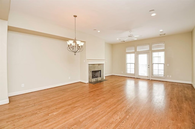 222 Knox St Unit F, Houston, TX 77007 - unfurnished living room featuring a chandelier, recessed lighting, light wood finished floors, a tiled fireplace, and ceiling fan