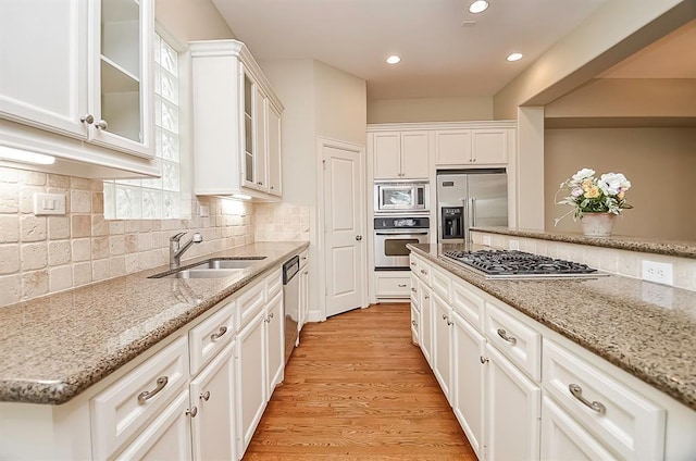 222 Knox St Unit F, Houston, TX 77007 - kitchen featuring built in appliances, white cabinetry, and recessed lighting