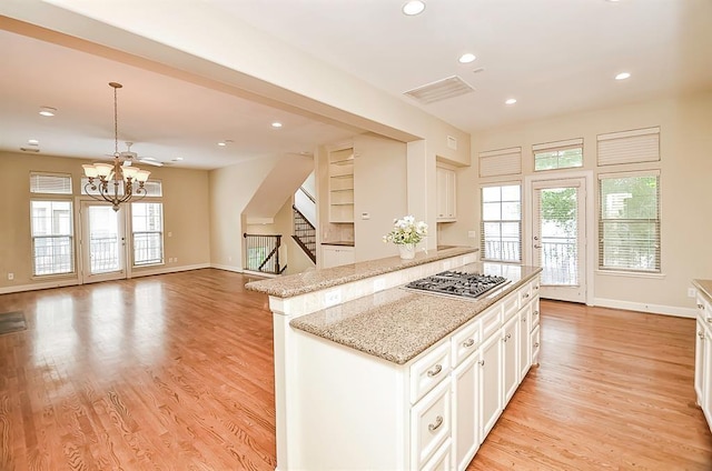 222 Knox St Unit F, Houston, TX 77007 - kitchen featuring stainless steel gas stovetop, plenty of natural light, a chandelier, white cabinetry, and recessed lighting