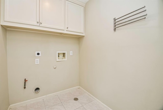 222 Knox St Unit F, Houston, TX 77007 - laundry room featuring hookup for a gas dryer, electric dryer hookup, washer hookup, light tile patterned floors, and cabinet space