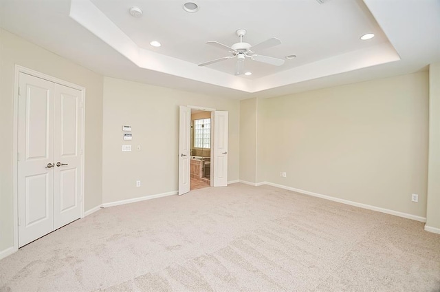 222 Knox St Unit F, Houston, TX 77007 - unfurnished bedroom featuring a raised ceiling, recessed lighting, light colored carpet, connected bathroom, and ceiling fan