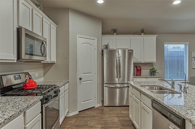 11503 Parrot Fish Ct, Conroe, TX 77304 - kitchen featuring appliances with stainless steel finishes, dark wood-style flooring, white cabinetry, recessed lighting, and light stone counters