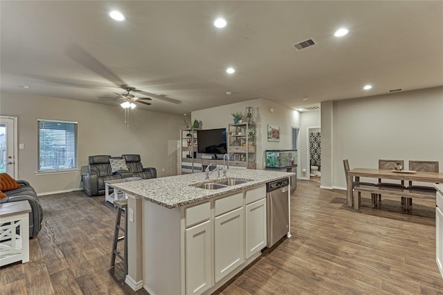 11503 Parrot Fish Ct, Conroe, TX 77304 - kitchen featuring dishwasher, open floor plan, a kitchen island with sink, dark wood-type flooring, and light stone countertops