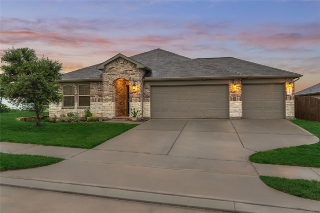 11503 Parrot Fish Ct, Conroe, TX 77304 - view of front facade with stone siding, an attached garage, driveway, and a lawn
