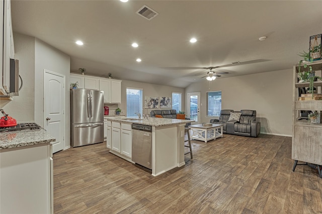 11503 Parrot Fish Ct, Conroe, TX 77304 - kitchen with appliances with stainless steel finishes, wood finished floors, open floor plan, a kitchen island with sink, and recessed lighting