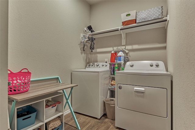 11503 Parrot Fish Ct, Conroe, TX 77304 - washroom with washing machine and clothes dryer, wood finished floors, and a textured wall