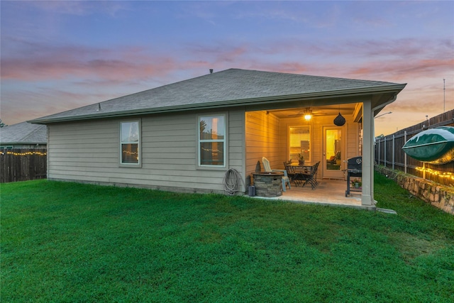 11503 Parrot Fish Ct, Conroe, TX 77304 - back of property at dusk featuring a patio, a fenced backyard, and a shingled roof