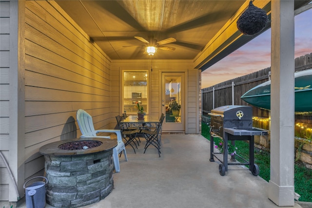 11503 Parrot Fish Ct, Conroe, TX 77304 - patio terrace at dusk with a fire pit, a patio, grilling area, and outdoor dining space