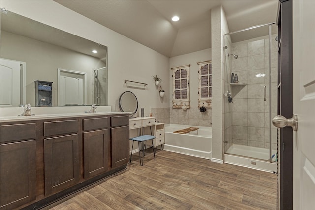 11503 Parrot Fish Ct, Conroe, TX 77304 - bathroom with a stall shower, a garden tub, wood finished floors, double vanity, and vaulted ceiling