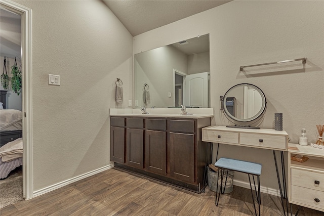 11503 Parrot Fish Ct, Conroe, TX 77304 - bathroom featuring ensuite bath, wood finished floors, a textured wall, and double vanity