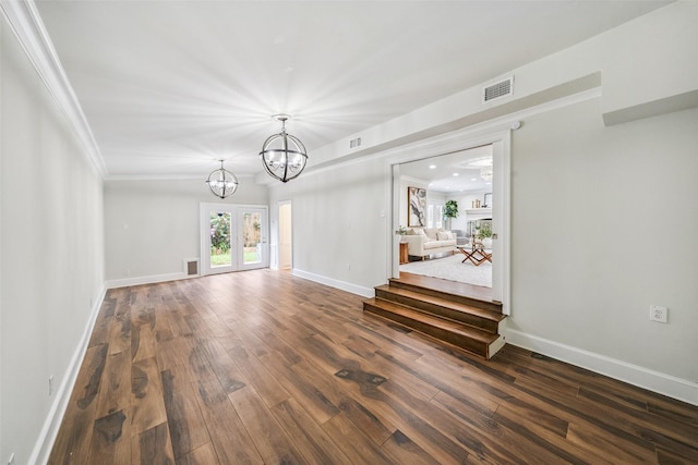 1114 W Cottage St, Houston, TX 77009 - spare room with dark wood-style floors, a chandelier, and ornamental molding