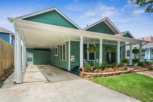 1114 W Cottage St, Houston, TX 77009 - view of front of home featuring driveway, covered porch, and a carport