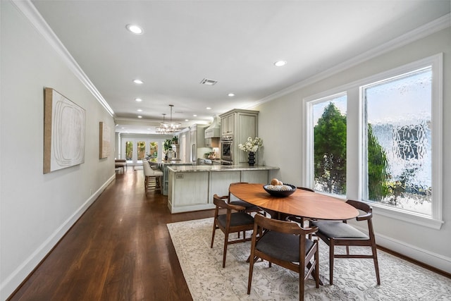 1114 W Cottage St, Houston, TX 77009 - dining area featuring recessed lighting, dark wood-type flooring, ornamental molding, and a chandelier
