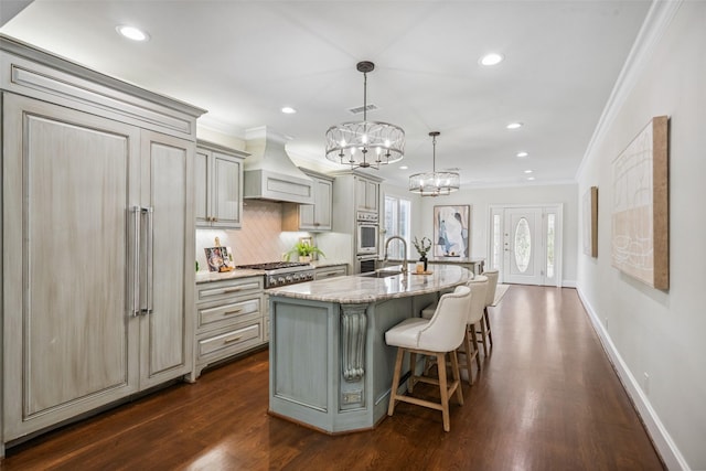 1114 W Cottage St, Houston, TX 77009 - kitchen with appliances with stainless steel finishes, custom range hood, gray cabinets, ornamental molding, and recessed lighting