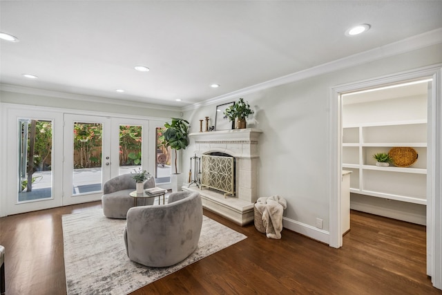1114 W Cottage St, Houston, TX 77009 - living room featuring ornamental molding, a fireplace with raised hearth, french doors, wood finished floors, and recessed lighting