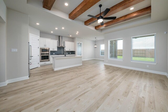 10506 Sutter Creek Dr, Iowa Colony, TX 77583 - unfurnished living room with ceiling fan, beam ceiling, light wood-style floors, and recessed lighting