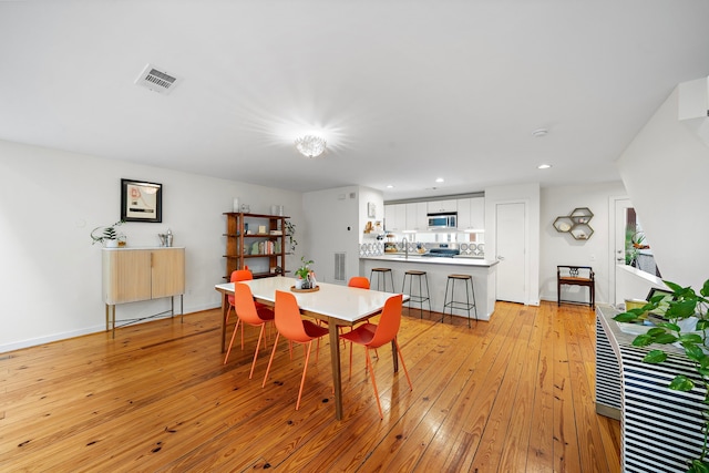 1821 Tuam St, Houston, TX 77004 - dining room with light wood-style flooring and recessed lighting