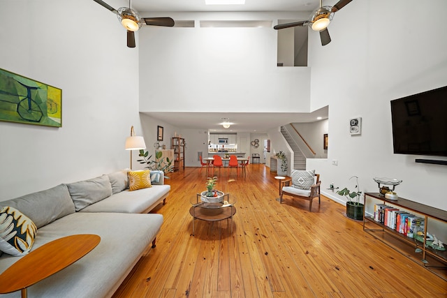1821 Tuam St, Houston, TX 77004 - living area with a ceiling fan, a high ceiling, stairway, and hardwood / wood-style floors