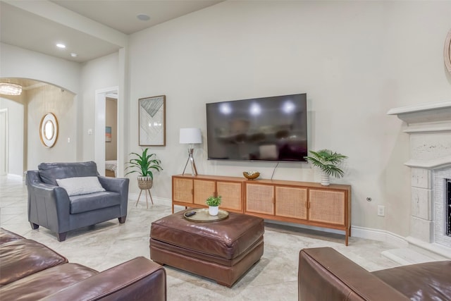 29114 Davenport Dr, Katy, TX 77494 - living room featuring arched walkways and a fireplace