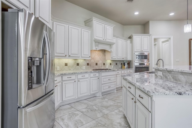 29114 Davenport Dr, Katy, TX 77494 - kitchen with appliances with stainless steel finishes, light marble finish floors, white cabinets, decorative backsplash, and decorative light fixtures