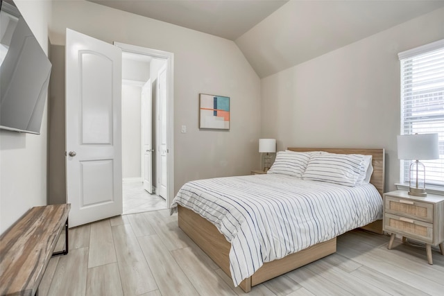 29114 Davenport Dr, Katy, TX 77494 - bedroom with multiple windows, lofted ceiling, and light wood-type flooring