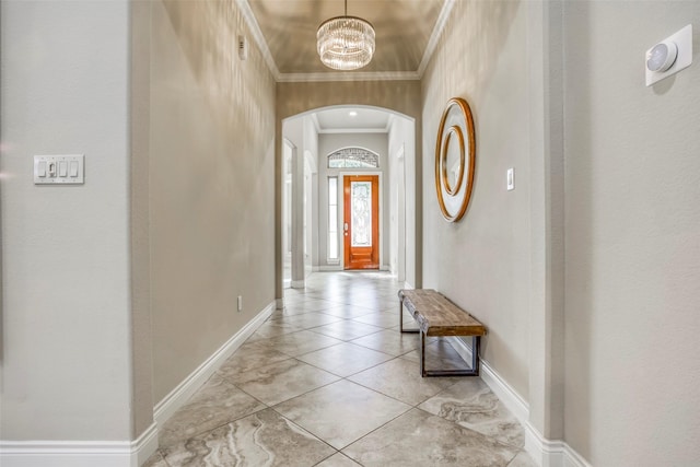 29114 Davenport Dr, Katy, TX 77494 - entryway featuring arched walkways, ornamental molding, a chandelier, and light tile patterned flooring