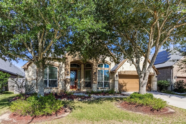 29114 Davenport Dr, Katy, TX 77494 - obstructed view of property with driveway, a garage, brick siding, and a front lawn