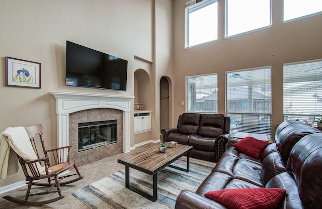 20303 Misty River Way, Cypress, TX 77433 - tiled living room with built in features, a tiled fireplace, and a towering ceiling