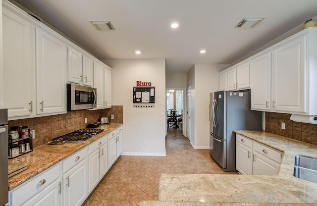 20303 Misty River Way, Cypress, TX 77433 - kitchen featuring stainless steel appliances, white cabinets, light tile patterned flooring, backsplash, and recessed lighting