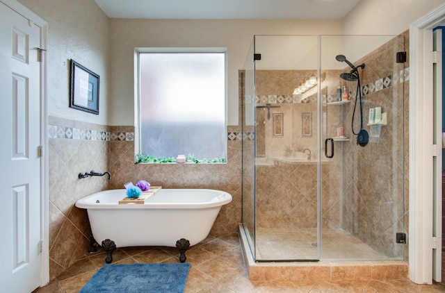 20303 Misty River Way, Cypress, TX 77433 - bathroom with healthy amount of natural light, a freestanding bath, a shower stall, tile walls, and tile patterned floors