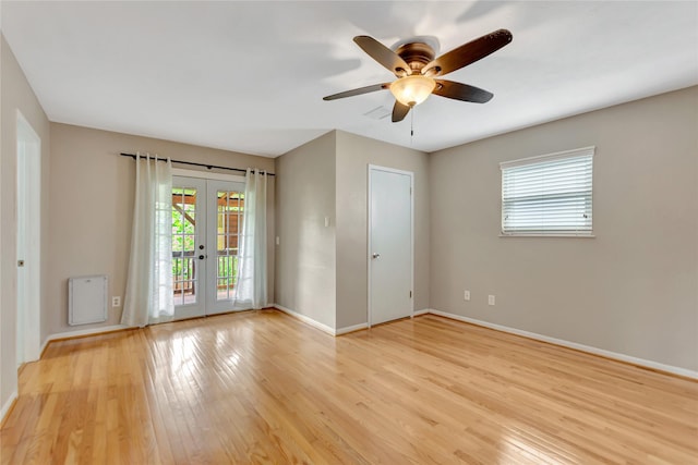 902 Grove Rd, Clear Lake Shores, TX 77565 - empty room with french doors, light wood-style floors, and ceiling fan