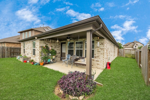 32726 Timber Point Dr, Brookshire, TX 77423 - rear view of house featuring a ceiling fan, brick siding, a patio area, and a fenced backyard
