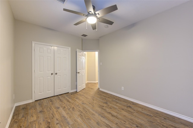 18511 Yellowstone Trl, Humble, TX 77346 - unfurnished bedroom with wood finished floors, a closet, and a ceiling fan