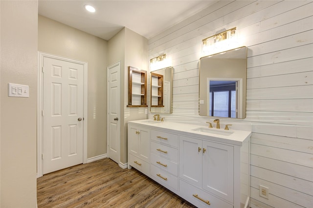 18511 Yellowstone Trl, Humble, TX 77346 - bathroom featuring wood finished floors, double vanity, wood walls, and recessed lighting