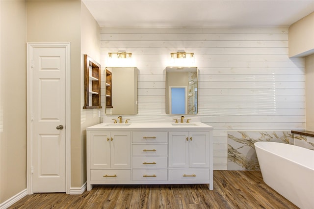 18511 Yellowstone Trl, Humble, TX 77346 - full bathroom featuring double vanity, a freestanding tub, and wood finished floors